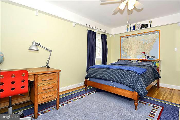10017 Portland Road Silver Spring, MD 20901 - Photo 19 of 30 a bedroom with a bed and wooden floor