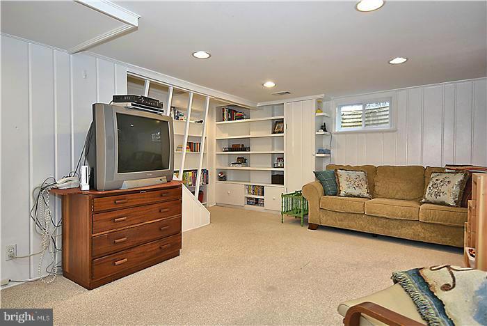 10017 Portland Road Silver Spring, MD 20901 - Photo 26 of 30 a living room with furniture and a flat screen tv