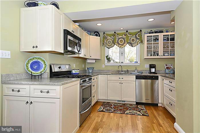 10017 Portland Road Silver Spring, MD 20901 - Photo 7 of 30 a kitchen with stainless steel appliances granite countertop a stove a sink and a microwave