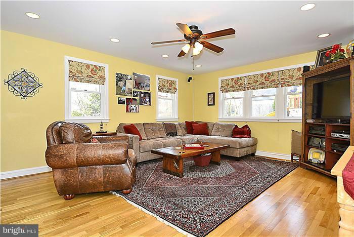 10017 Portland Road Silver Spring, MD 20901 - Photo 10 of 30 a living room with fireplace furniture and a flat screen tv