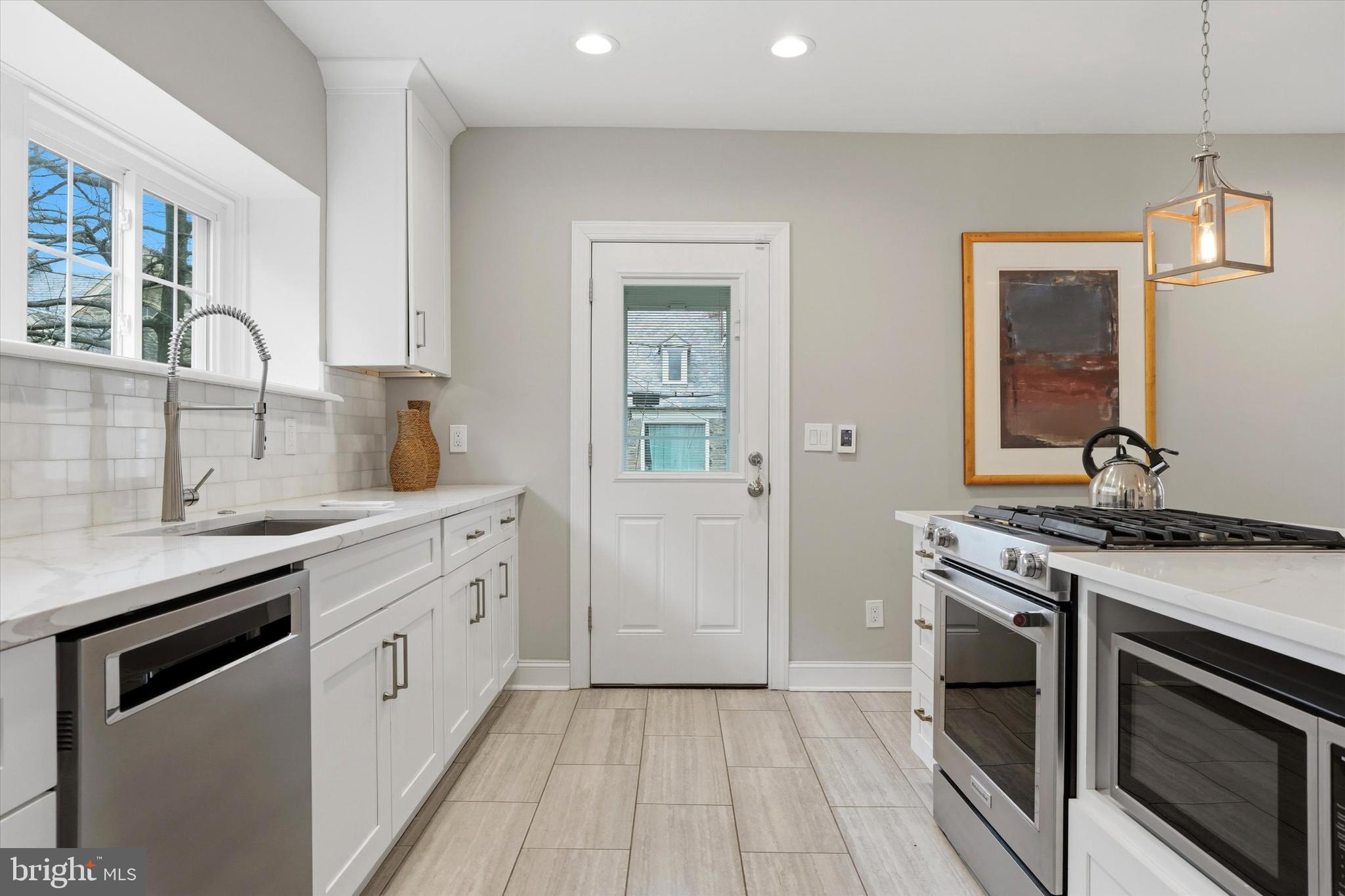 507 Murdoch Road Philadelphia, PA 19119 - Photo 16 of 52 a kitchen with stainless steel appliances granite countertop a stove and a sink