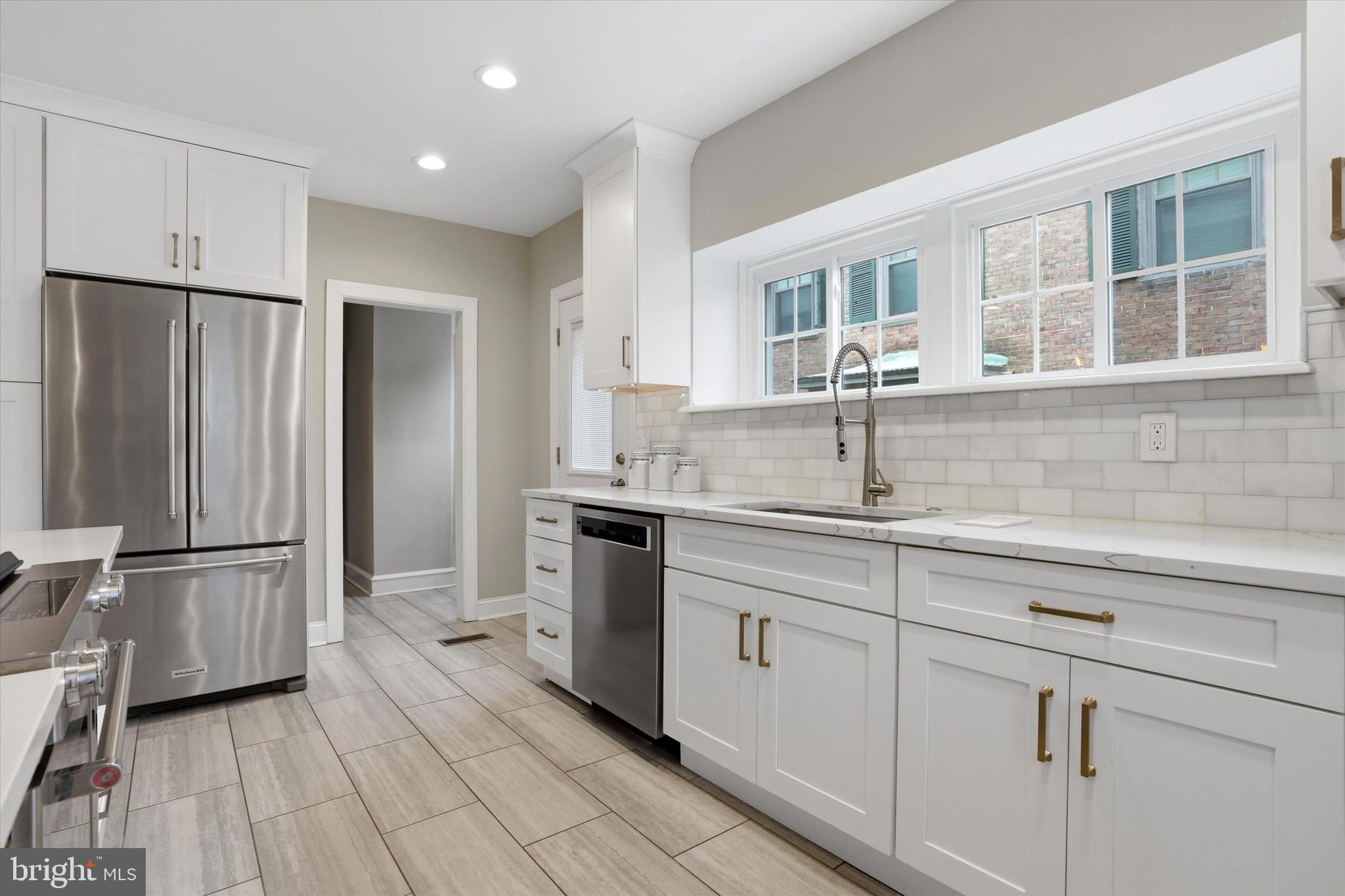507 Murdoch Road Philadelphia, PA 19119 - Photo 17 of 52 a kitchen with stainless steel appliances granite countertop a refrigerator and a sink