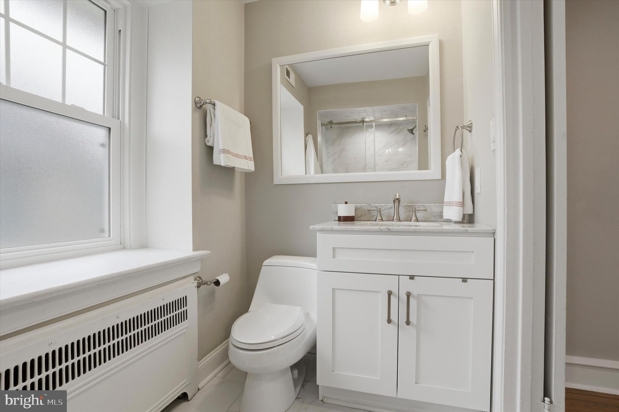 507 Murdoch Road Philadelphia, PA 19119 - Photo 23 of 52 a bathroom with a toilet sink vanity and mirror