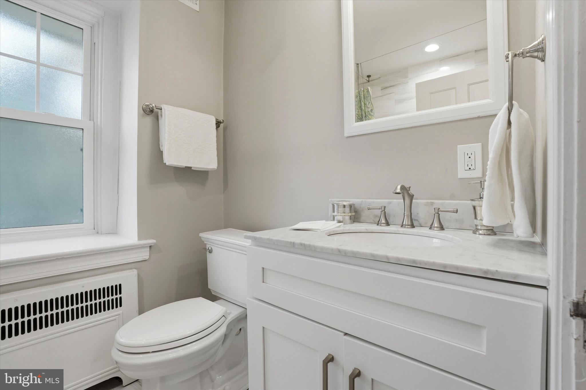 507 Murdoch Road Philadelphia, PA 19119 - Photo 26 of 52 a bathroom with a granite countertop toilet sink and mirror