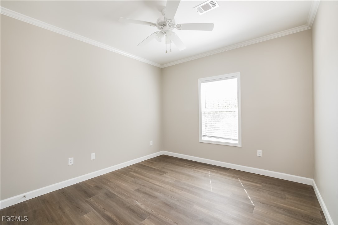12319 Tangier Street North Port, FL 34287 - Photo 11 of 16 an empty room with a window and a ceiling fan
