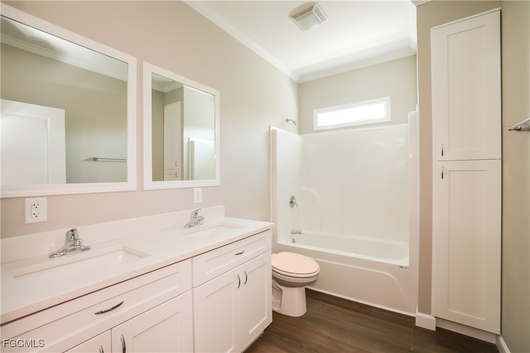 12319 Tangier Street North Port, FL 34287 - Photo 14 of 16 a bathroom with a bathtub shower sink vanity mirror and toilet