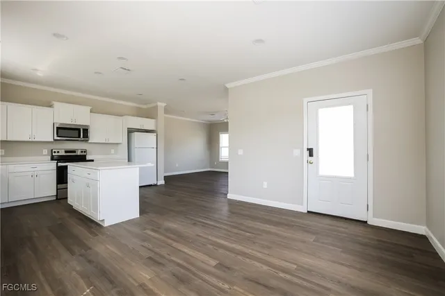 a view of kitchen with wooden floor and electronic appliances