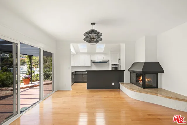 a kitchen with stainless steel appliances granite countertop a stove and a large window