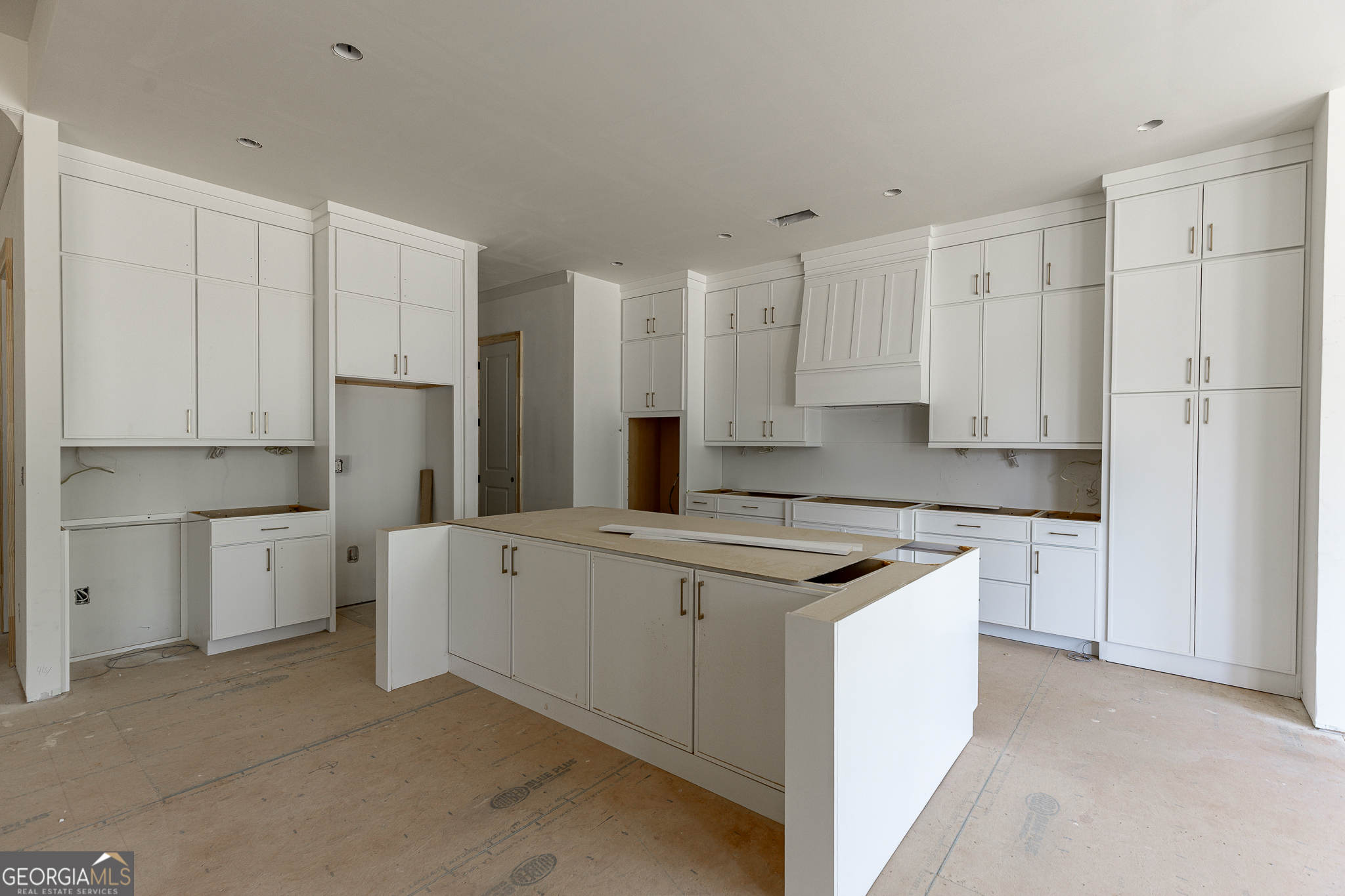 2969 North Bogan Road Northeast, Unit 1 Buford, GA 30519 - Photo 16 of 51 a kitchen with white cabinets and white appliances