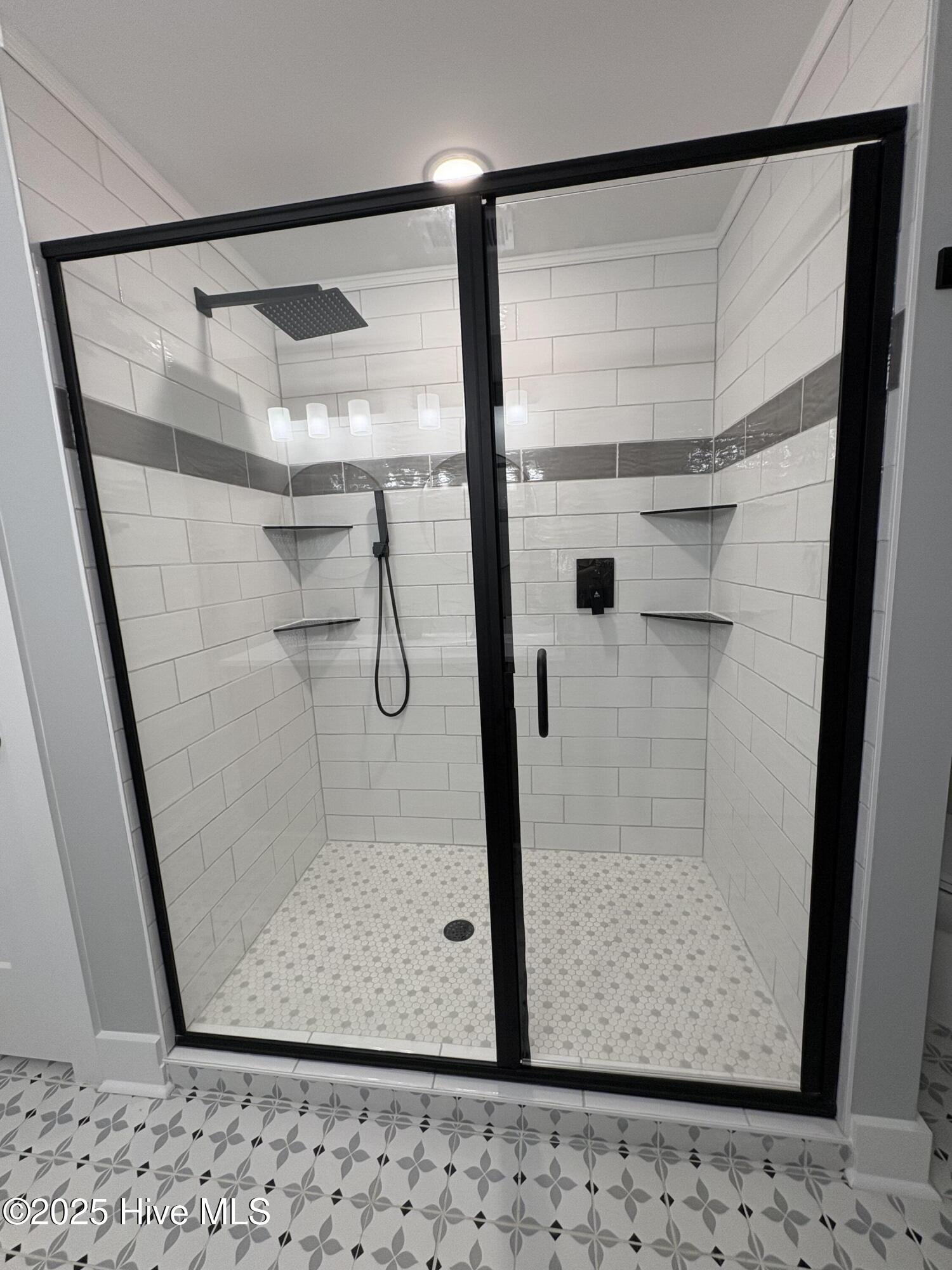 599 Bitmore Road Whiteville, NC 28472 - Photo 17 of 23 Floor to ceiling tile with rain shower head.