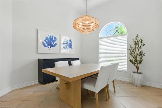 a view of a dining room that has a table and a chair