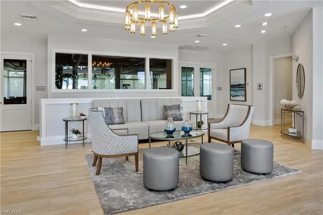 a living room with furniture and a chandelier