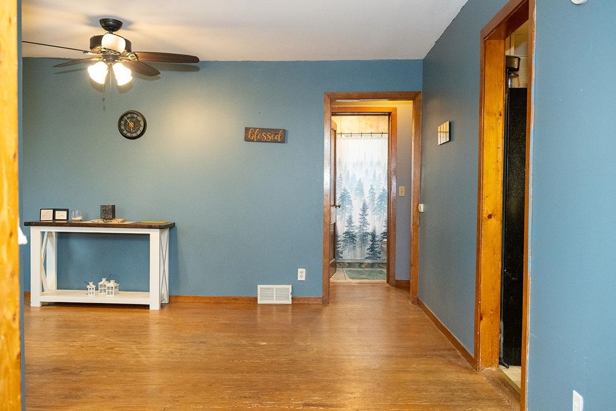 503 West 2nd Street Byron, IL 61010 - Photo 12 of 56 a view of a livingroom with a fireplace a ceiling fan and front door