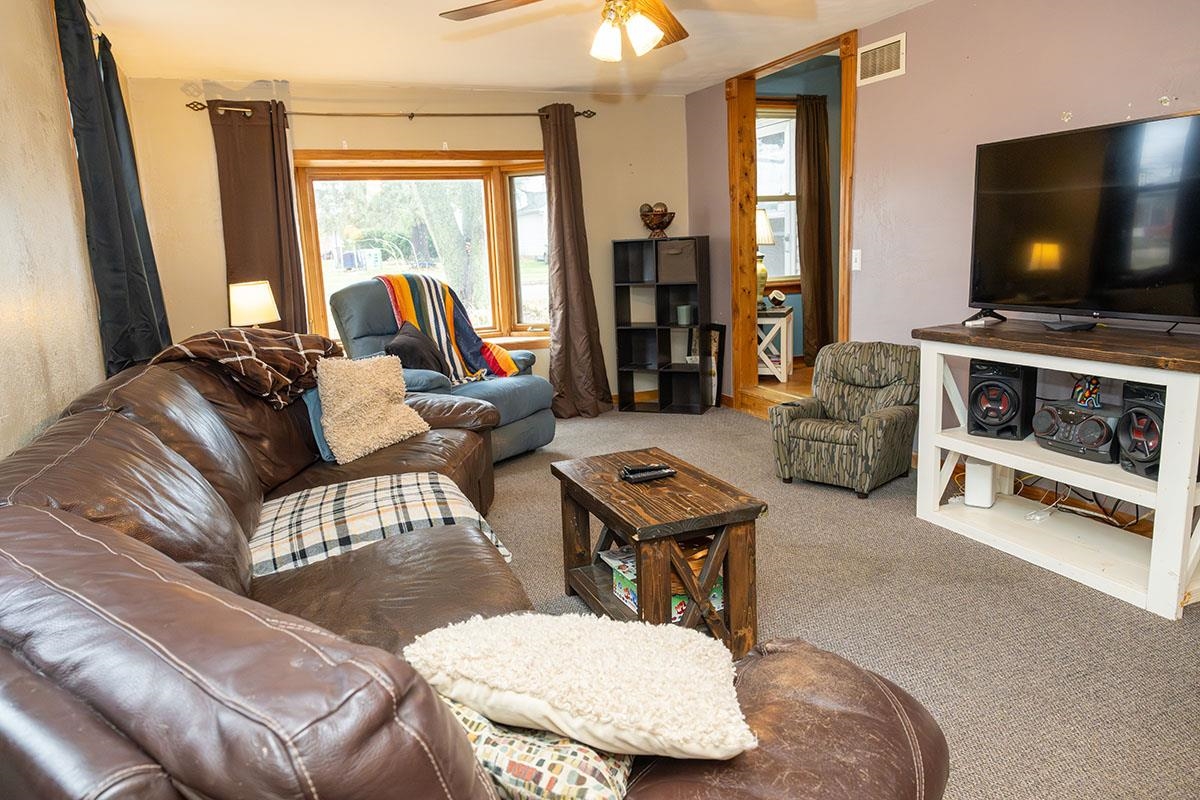 503 West 2nd Street Byron, IL 61010 - Photo 14 of 56 a living room with furniture and a flat screen tv