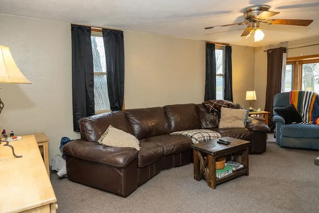 a living room with furniture and a chandelier
