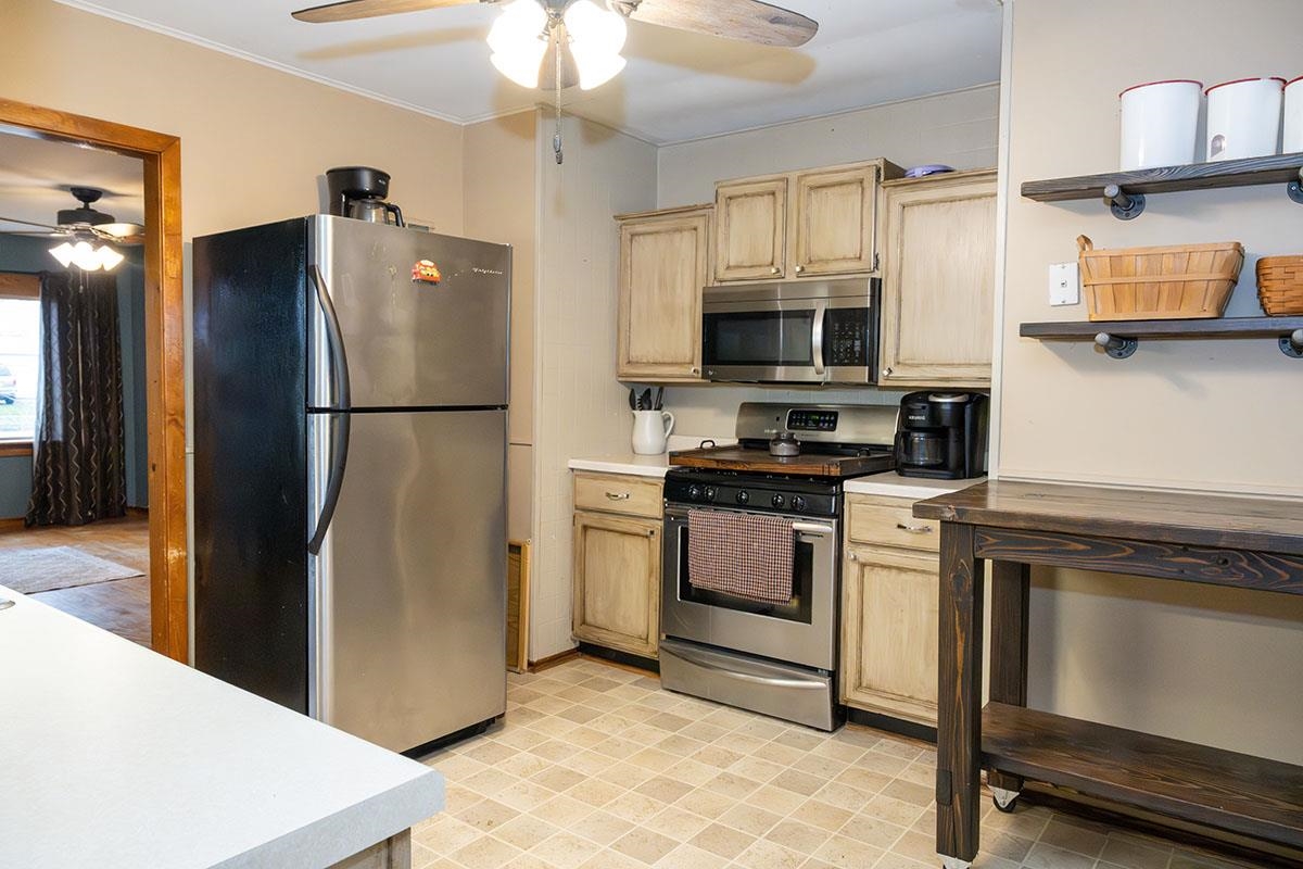 503 West 2nd Street Byron, IL 61010 - Photo 18 of 56 a kitchen with stainless steel appliances a refrigerator stove and microwave