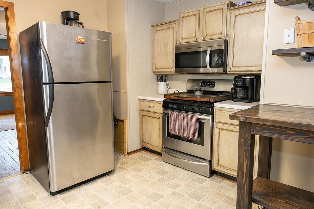 503 West 2nd Street Byron, IL 61010 - Photo 19 of 56 a white refrigerator freezer and a stove sitting inside of a kitchen