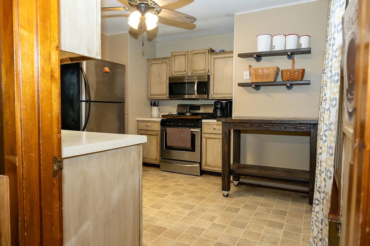 503 West 2nd Street Byron, IL 61010 - Photo 20 of 56 a kitchen with stainless steel appliances a refrigerator and a stove top oven