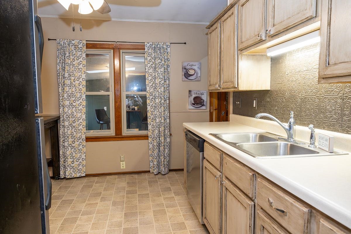 503 West 2nd Street Byron, IL 61010 - Photo 22 of 56 a kitchen with a sink and a refrigerator
