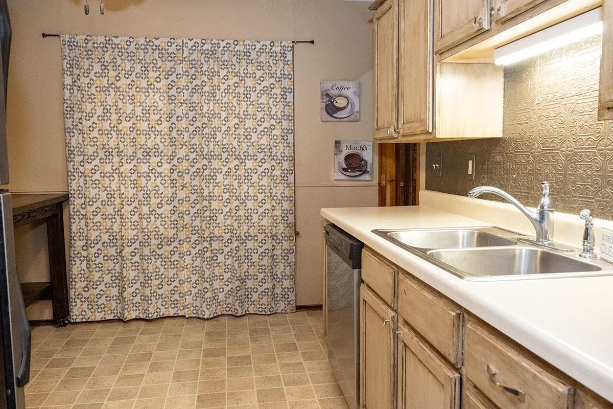 503 West 2nd Street Byron, IL 61010 - Photo 23 of 56 a kitchen with a sink and a refrigerator