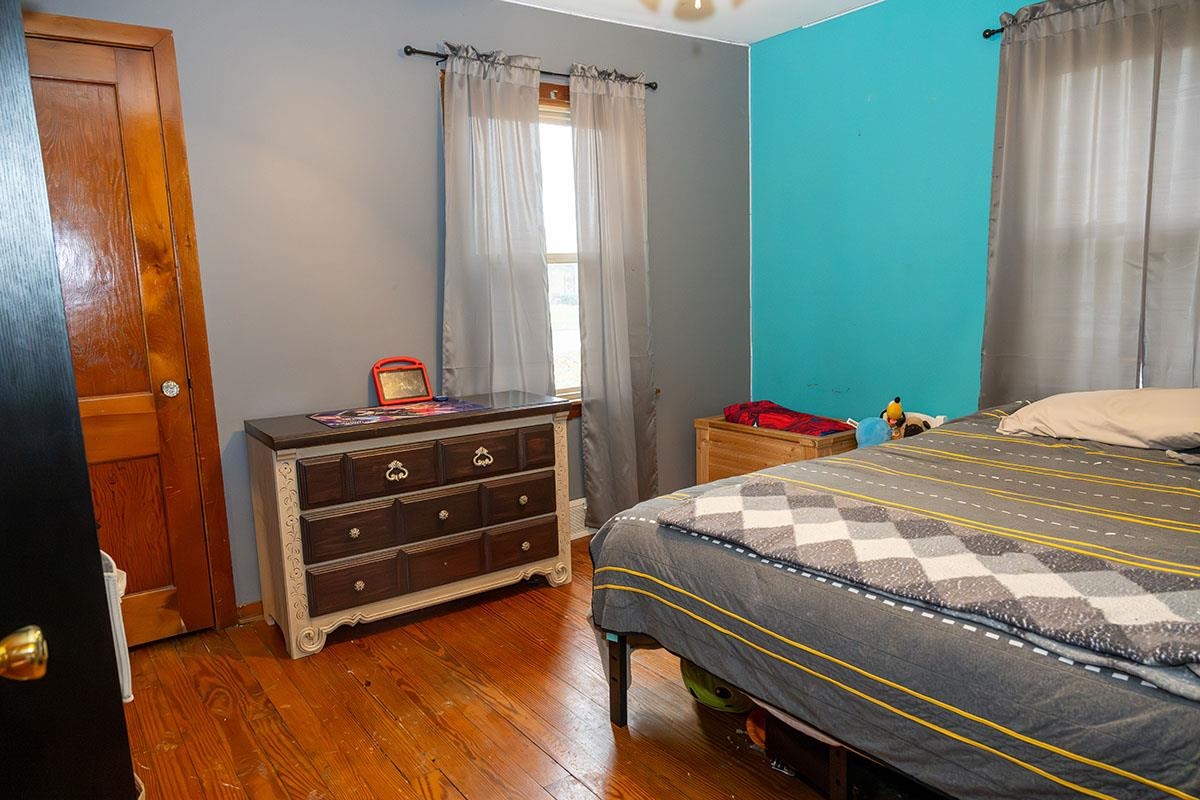 503 West 2nd Street Byron, IL 61010 - Photo 30 of 56 a bedroom with a bed and wooden floor