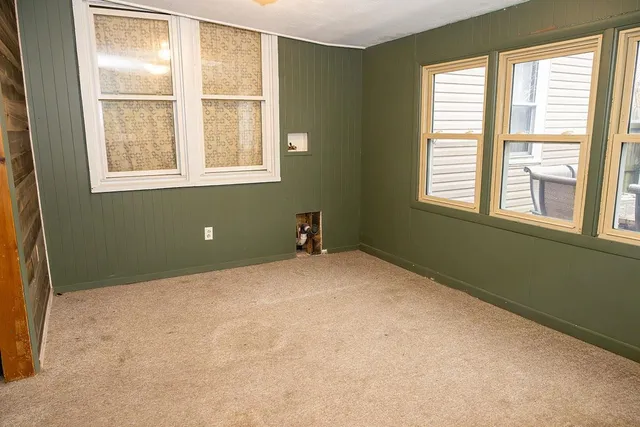 a view of a room with a window and furniture
