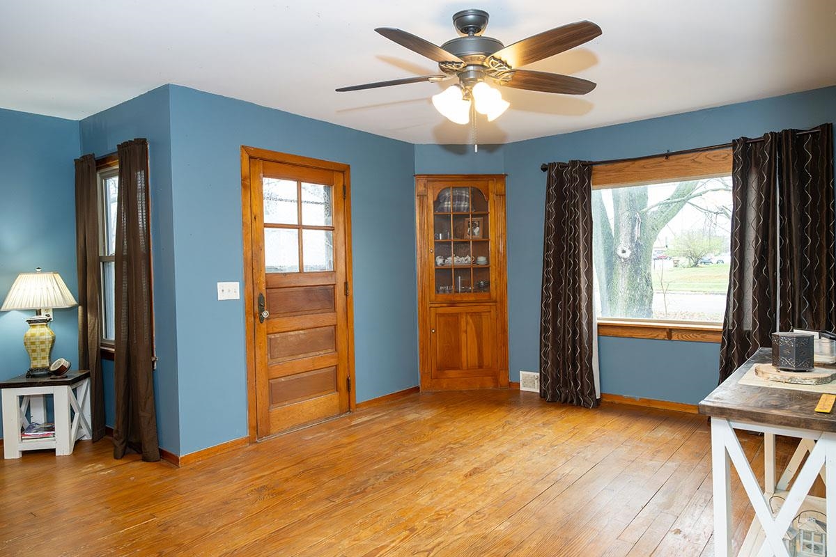 503 West 2nd Street Byron, IL 61010 - Photo 6 of 56 a view of livingroom with hardwood floor and a ceiling fan