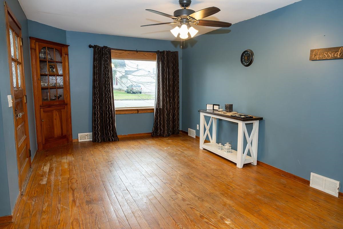 503 West 2nd Street Byron, IL 61010 - Photo 9 of 56 wooden floor in an empty room with a window