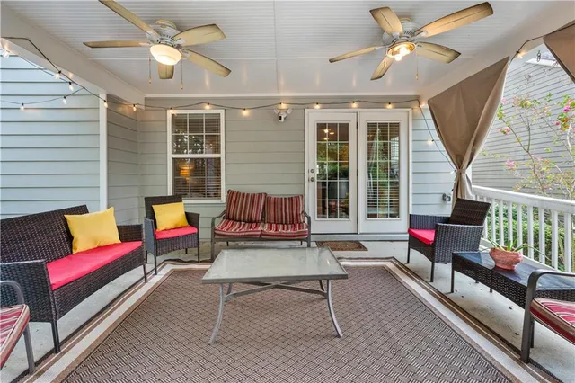 a living room with furniture and a floor to ceiling window