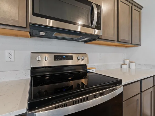 a kitchen with stainless steel appliances a stove and a microwave