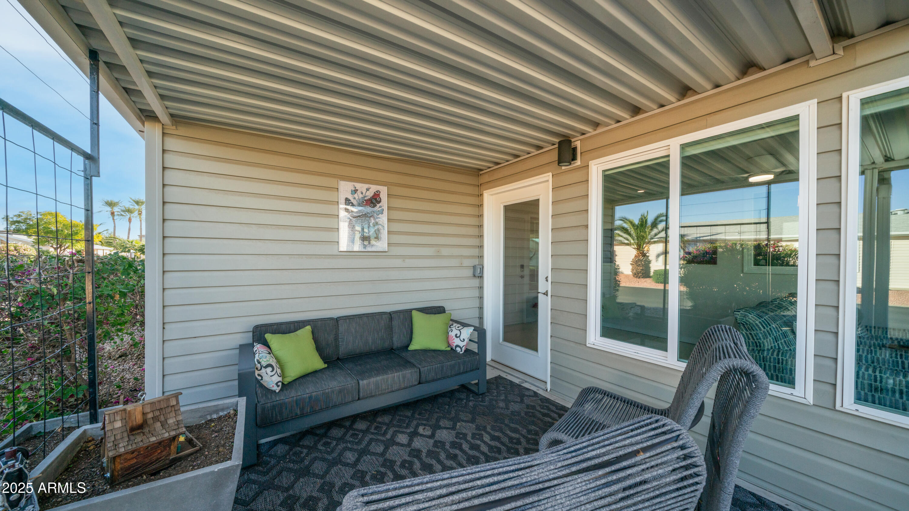 2550 South Ellsworth Road, Unit 751 Mesa, AZ 85209 - Photo 25 of 27 a view of a patio with couches chairs and a potted plant