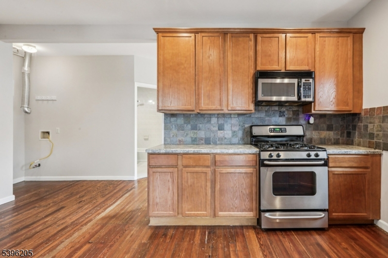 507 Bloomfield Avenue Nutley, NJ 07110 - Photo 15 of 26 a kitchen with a stove a sink and a microwave