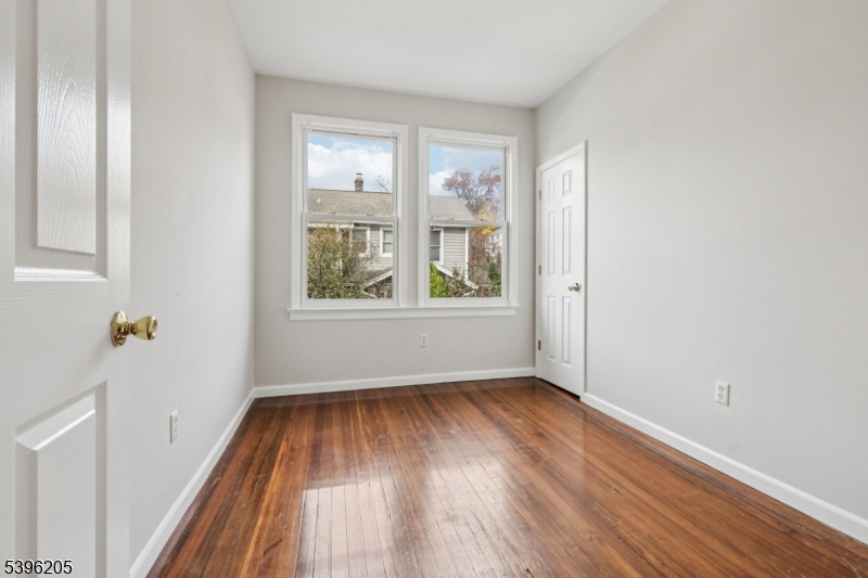 507 Bloomfield Avenue Nutley, NJ 07110 - Photo 19 of 26 an empty room with wooden floor and windows