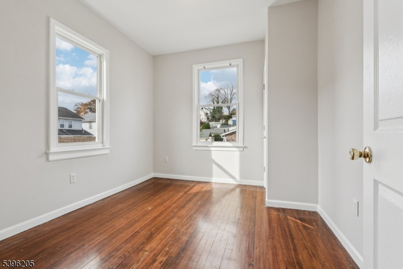 507 Bloomfield Avenue Nutley, NJ 07110 - Photo 21 of 26 a view of an empty room with wooden floor and a window