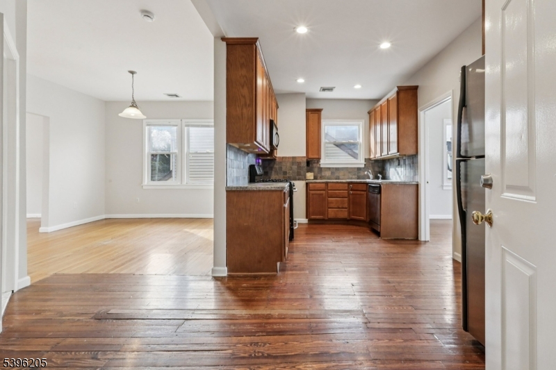 507 Bloomfield Avenue Nutley, NJ 07110 - Photo 8 of 26 a open kitchen with stainless steel appliances granite countertop a refrigerator a stove oven and a wooden cabinets