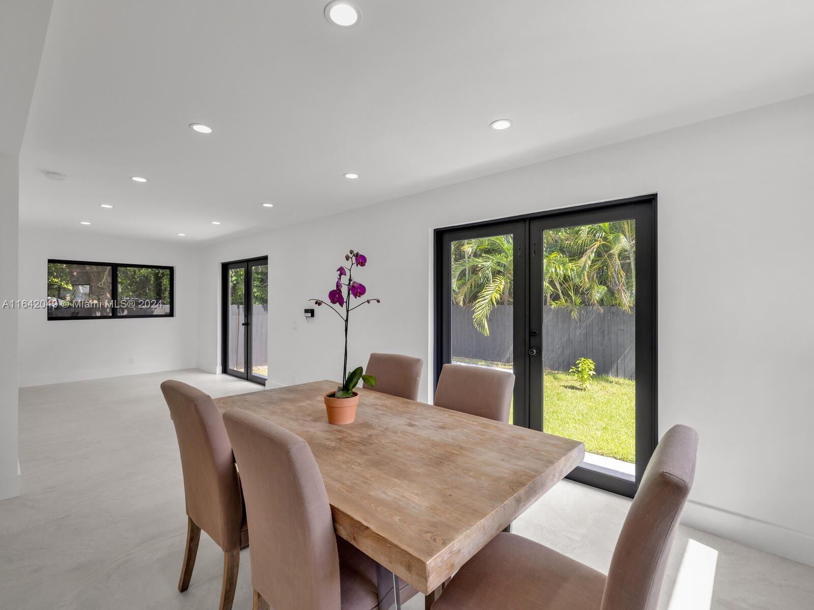 5991 Southwest 45th Street Miami, FL 33155 - Photo 12 of 35 a view of a dining room with furniture window and outside view