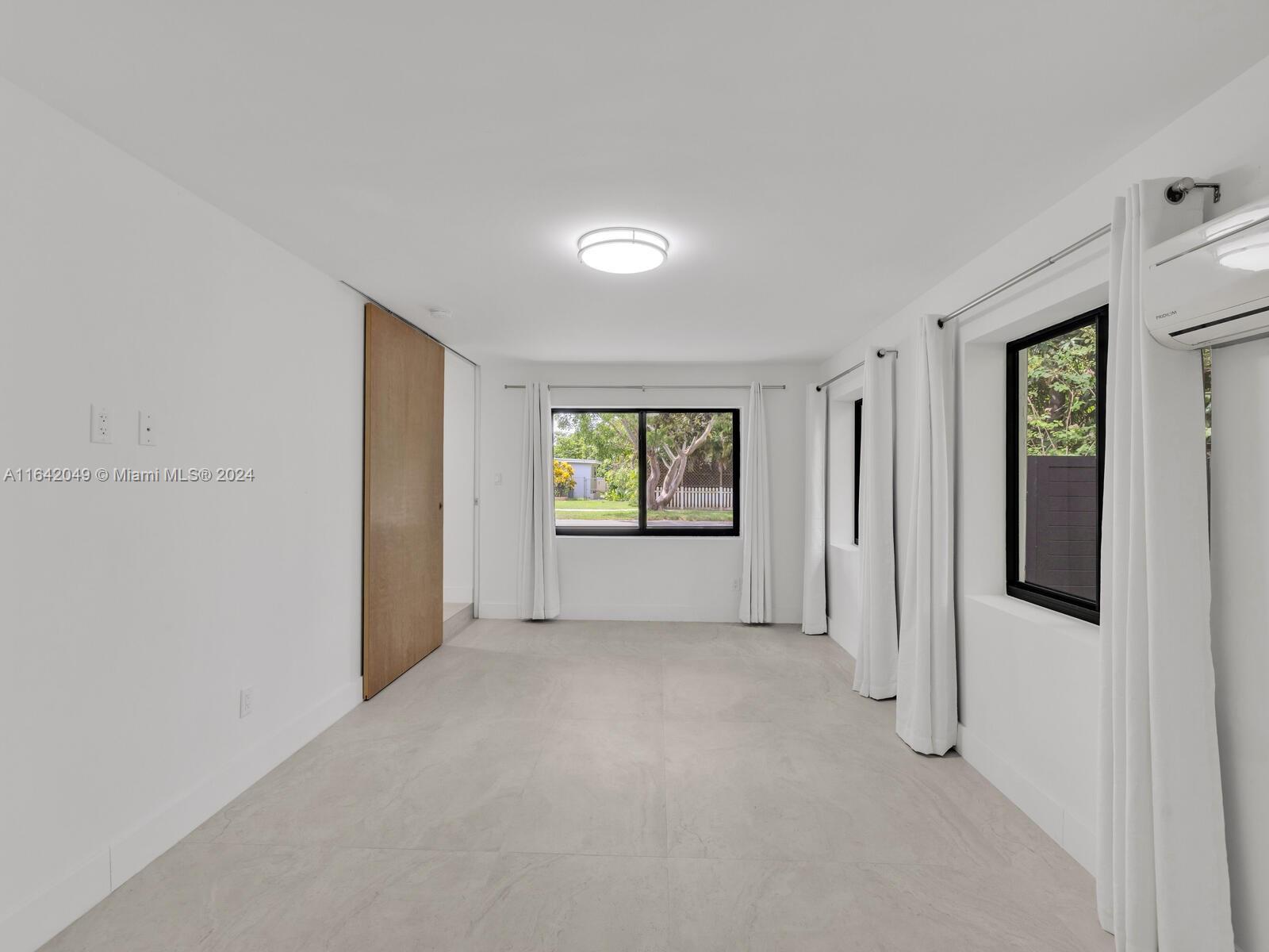 5991 Southwest 45th Street Miami, FL 33155 - Photo 18 of 35 a view of an empty room with a window