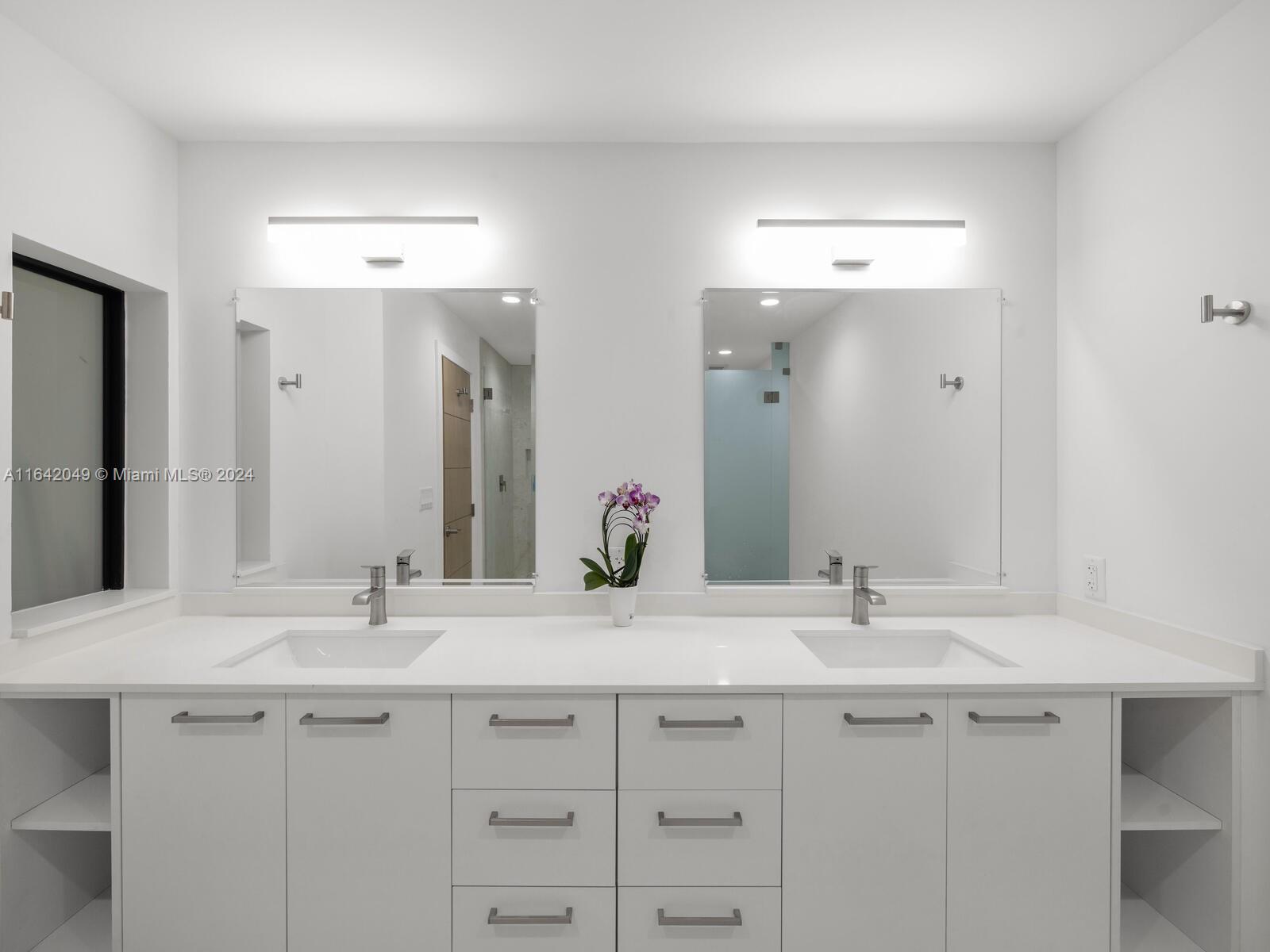 5991 Southwest 45th Street Miami, FL 33155 - Photo 19 of 35 a bathroom with double sink and a mirror