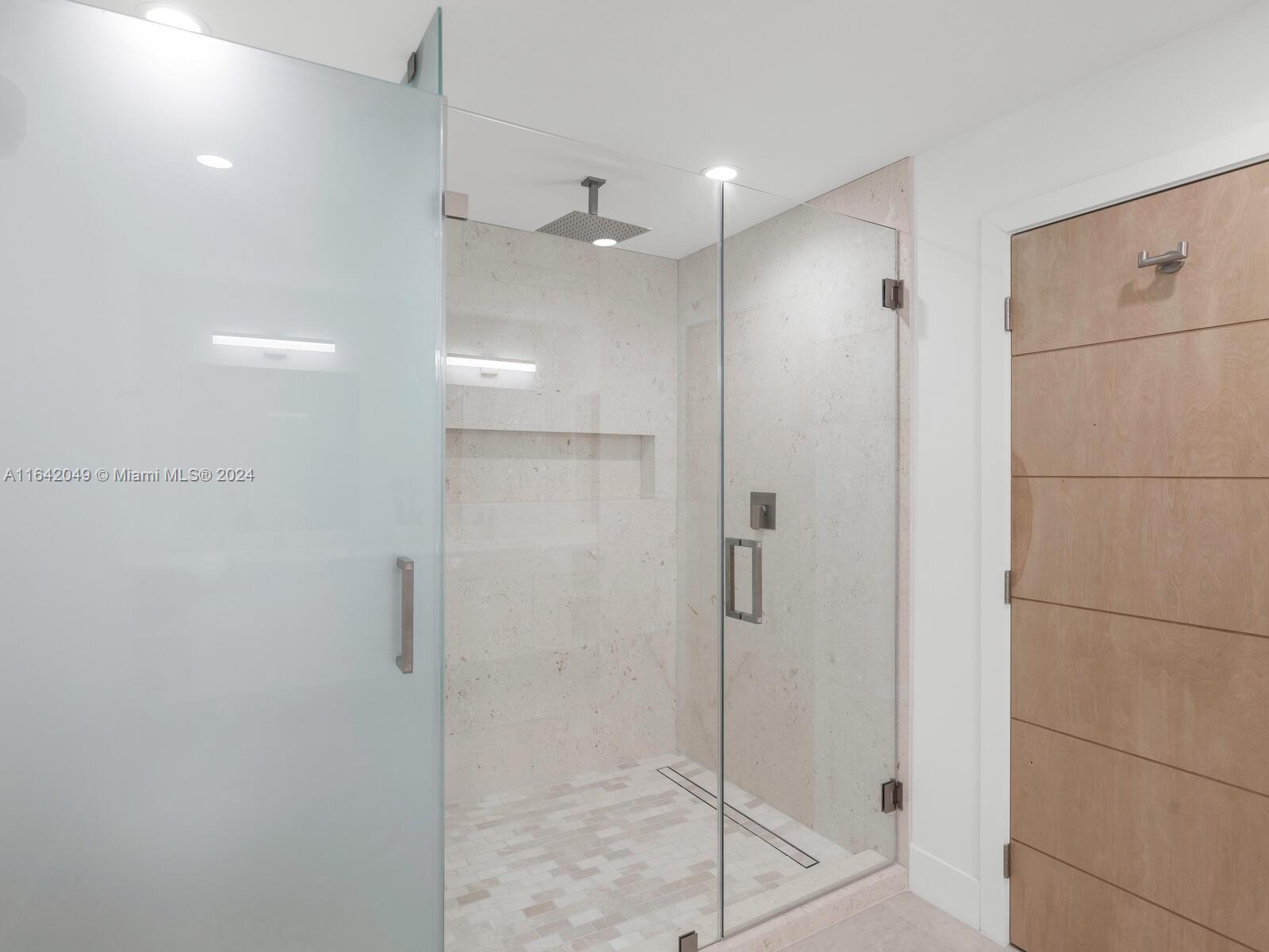 5991 Southwest 45th Street Miami, FL 33155 - Photo 20 of 35 a bathroom with a shower and a glass door