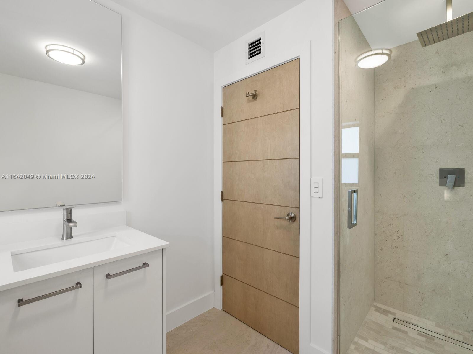 5991 Southwest 45th Street Miami, FL 33155 - Photo 23 of 35 a bathroom with a shower sink and mirror