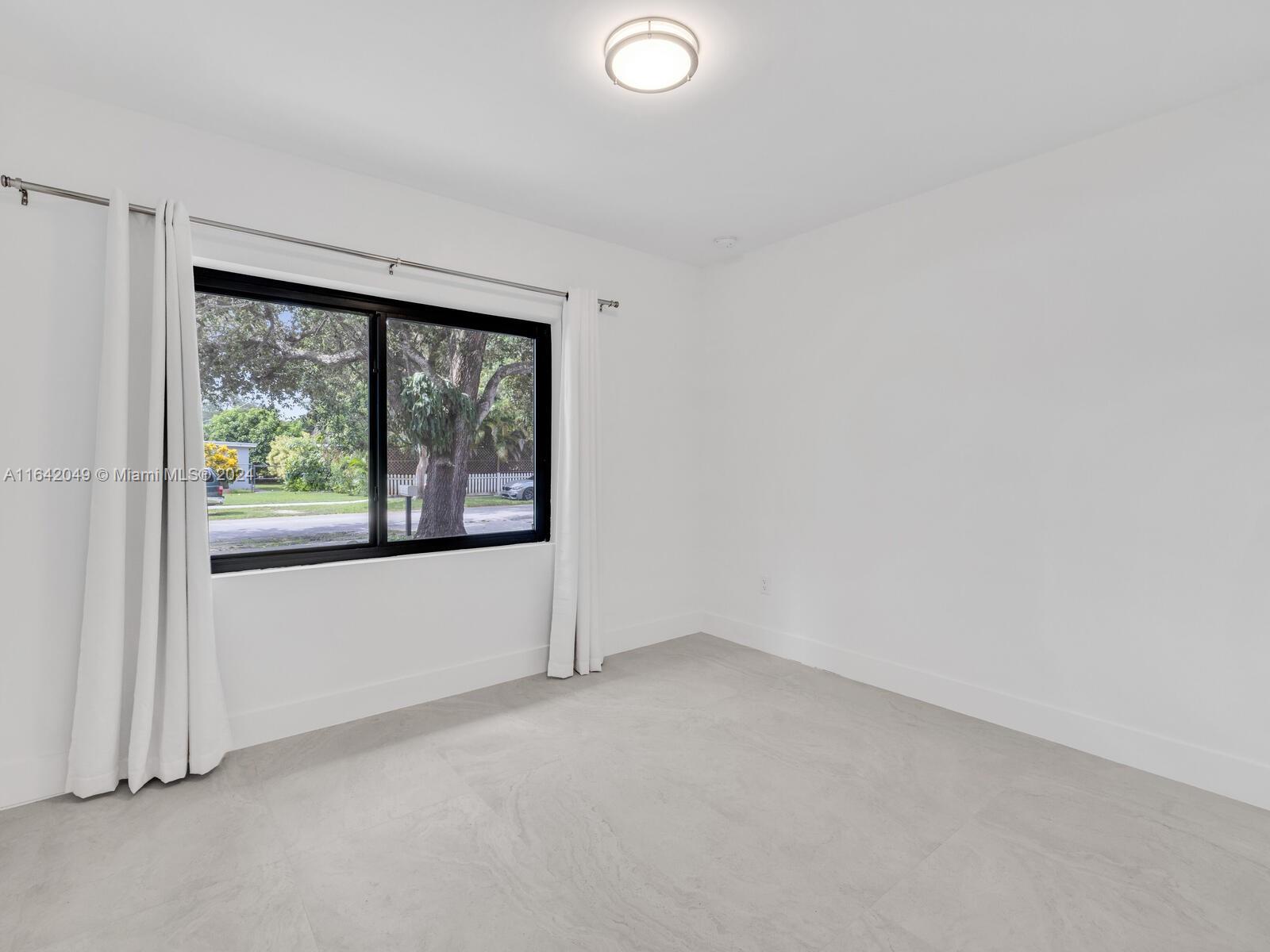 5991 Southwest 45th Street Miami, FL 33155 - Photo 27 of 35 an empty room with windows