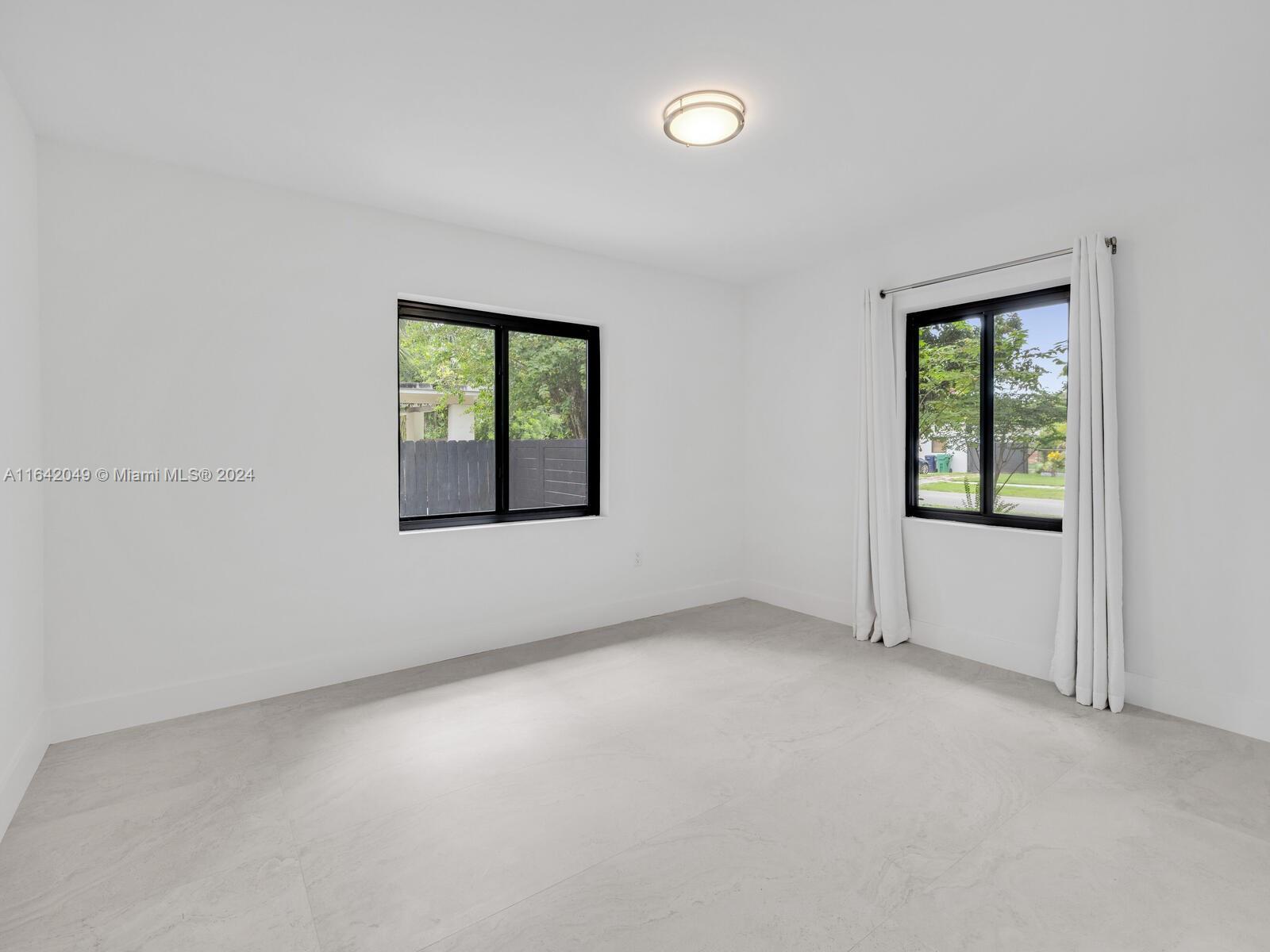5991 Southwest 45th Street Miami, FL 33155 - Photo 29 of 35 an empty room with windows