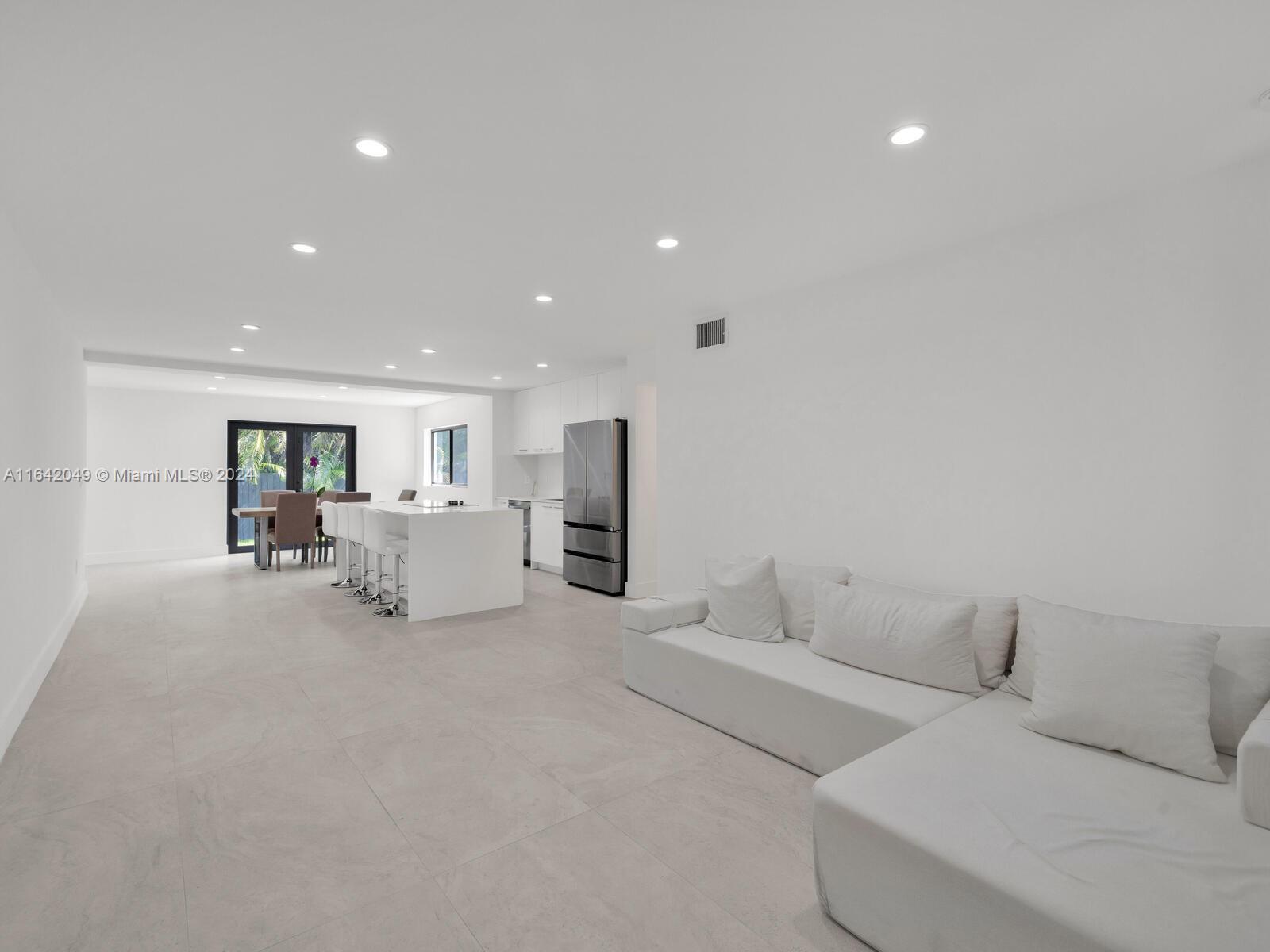 5991 Southwest 45th Street Miami, FL 33155 - Photo 4 of 35 a living room with furniture and white bed