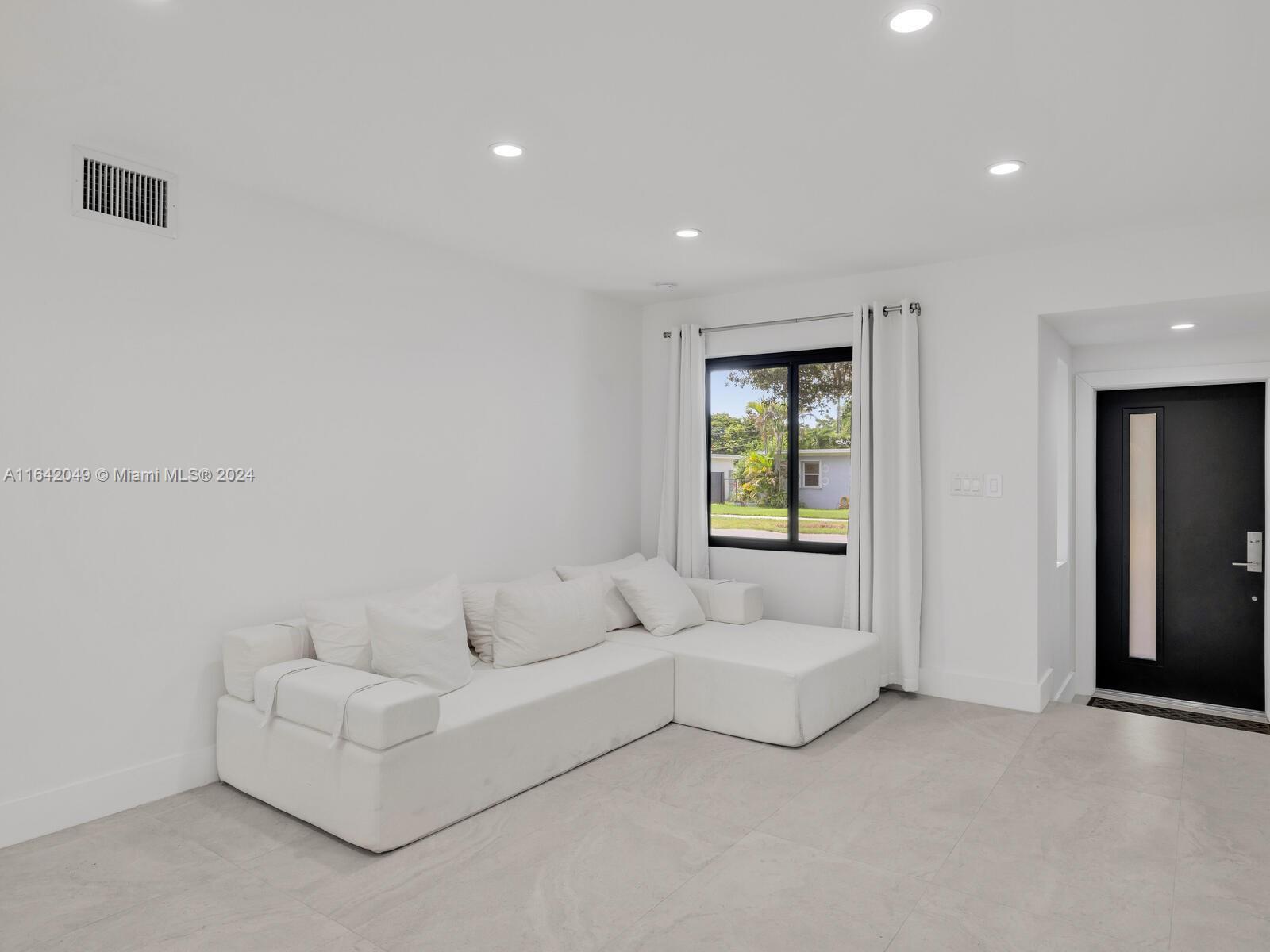 5991 Southwest 45th Street Miami, FL 33155 - Photo 6 of 35 a living room with furniture and a window
