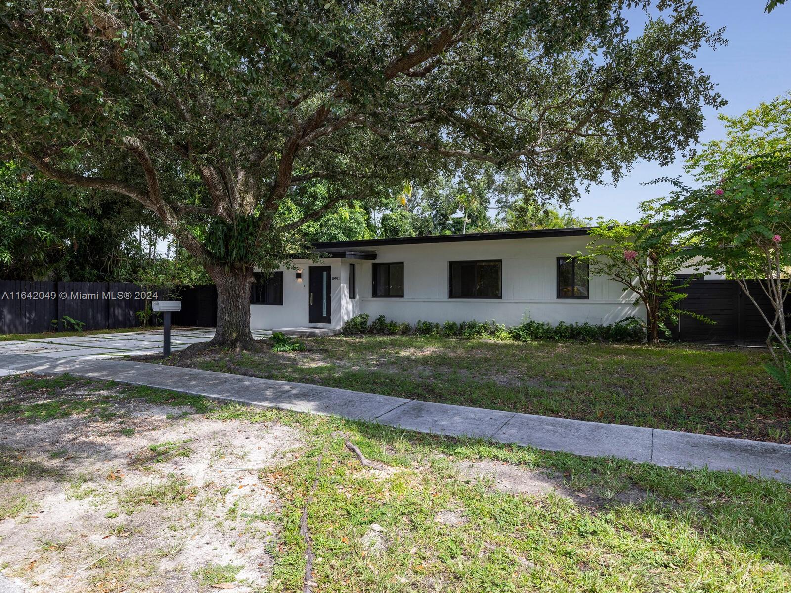 5991 Southwest 45th Street Miami, FL 33155 - Photo 10 of 35 a front view of house with yard and green space