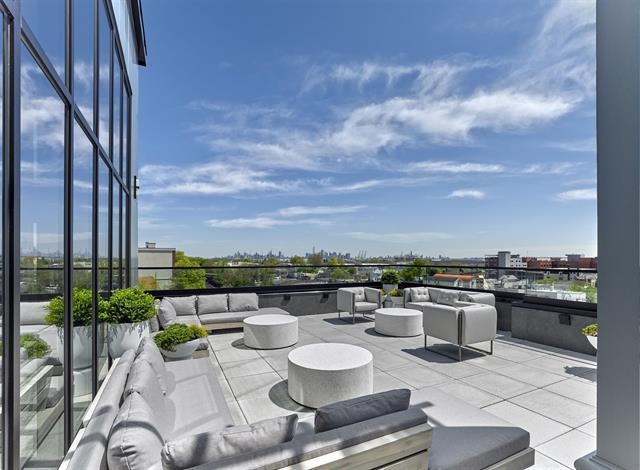260 Ave East, Unit 609 Bayonne, NJ 07002 - Photo 22 of 24 a view of a terrace with furniture
