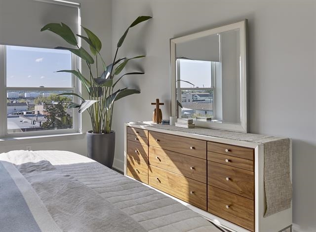 260 Ave East, Unit 609 Bayonne, NJ 07002 - Photo 5 of 24 a spacious bathroom with a large mirror and a potted plant