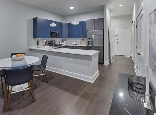 260 Ave East, Unit 609 Bayonne, NJ 07002 - Photo 10 of 24 a kitchen with stainless steel appliances granite countertop a refrigerator sink and cabinets