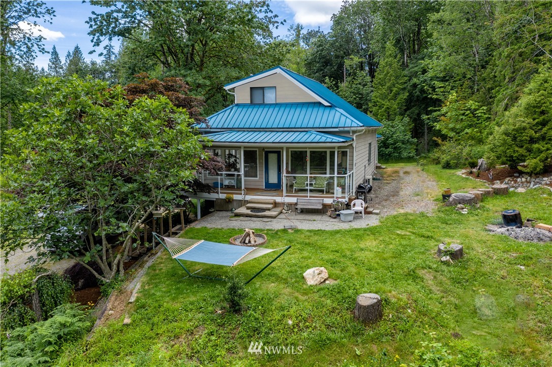 3635 H Street Road Blaine, WA 98230 - Photo 1 of 16 a view of a patio with table and chairs potted plants and large tree
