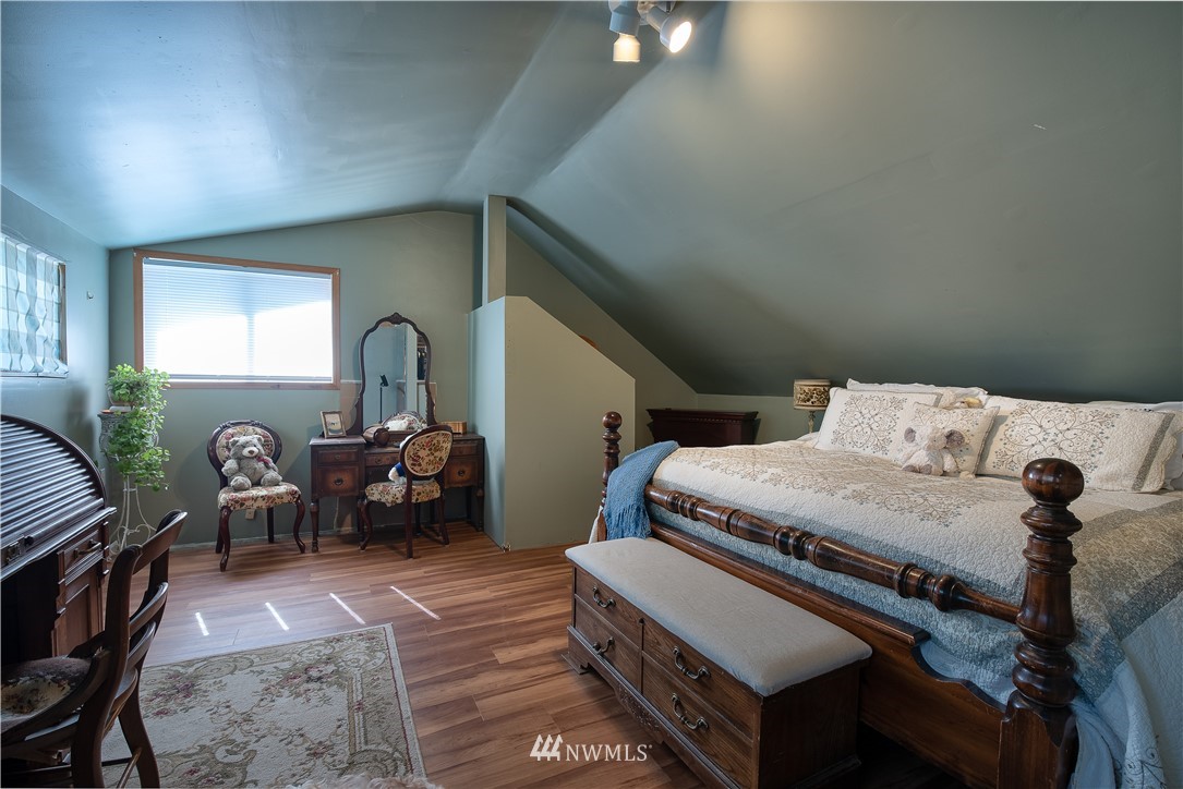 3635 H Street Road Blaine, WA 98230 - Photo 10 of 16 a bedroom with furniture and a chair